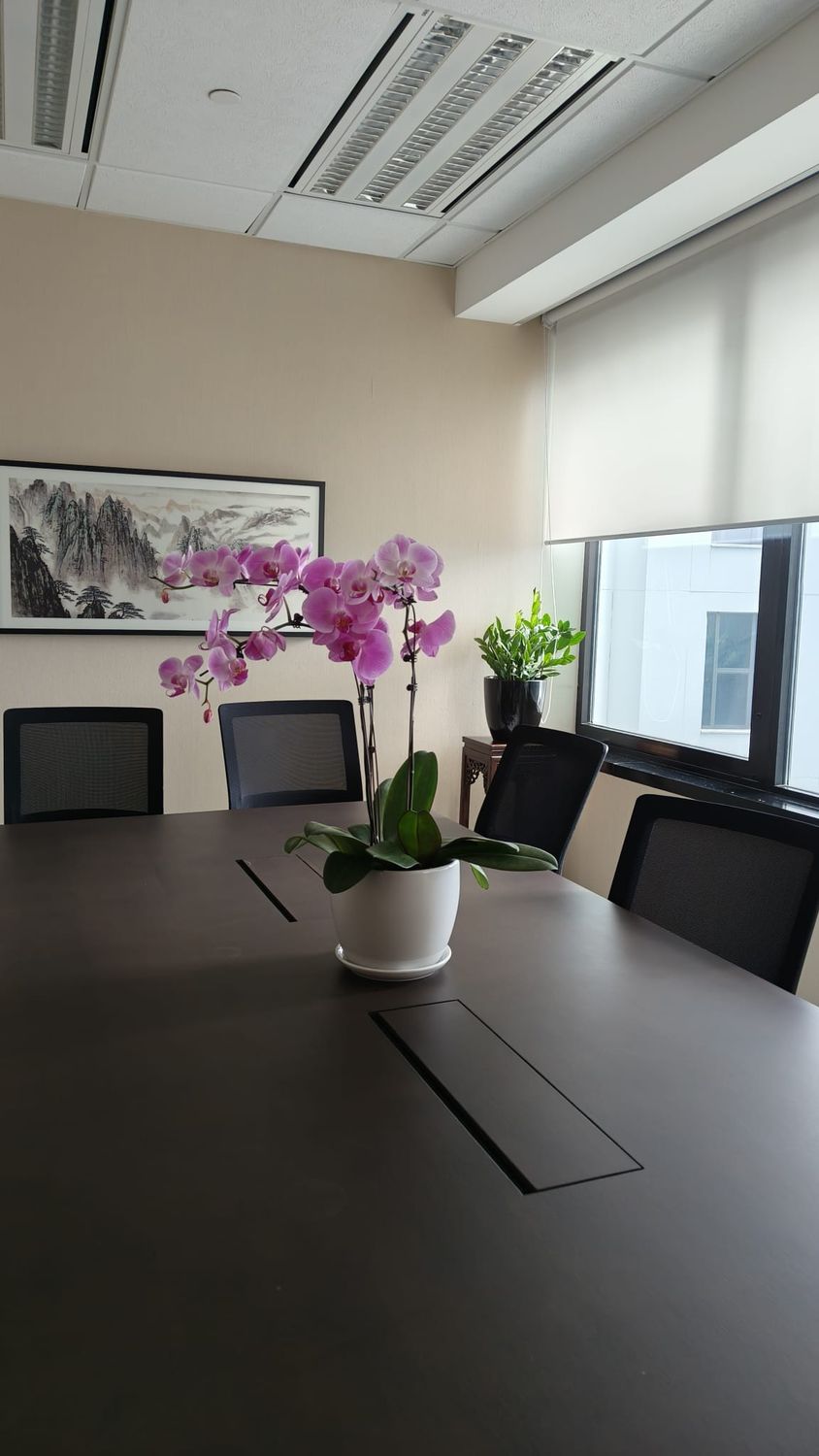 Pink orchid arrangement centred on a boardroom table