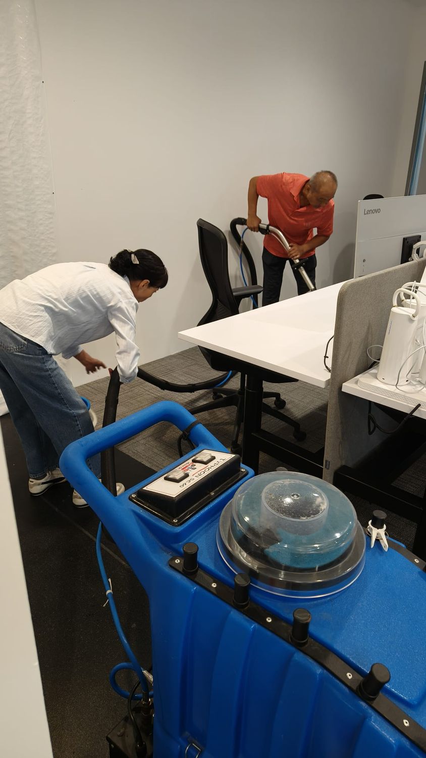 Hot-water extraction machine shampooing office carpet in Singapore