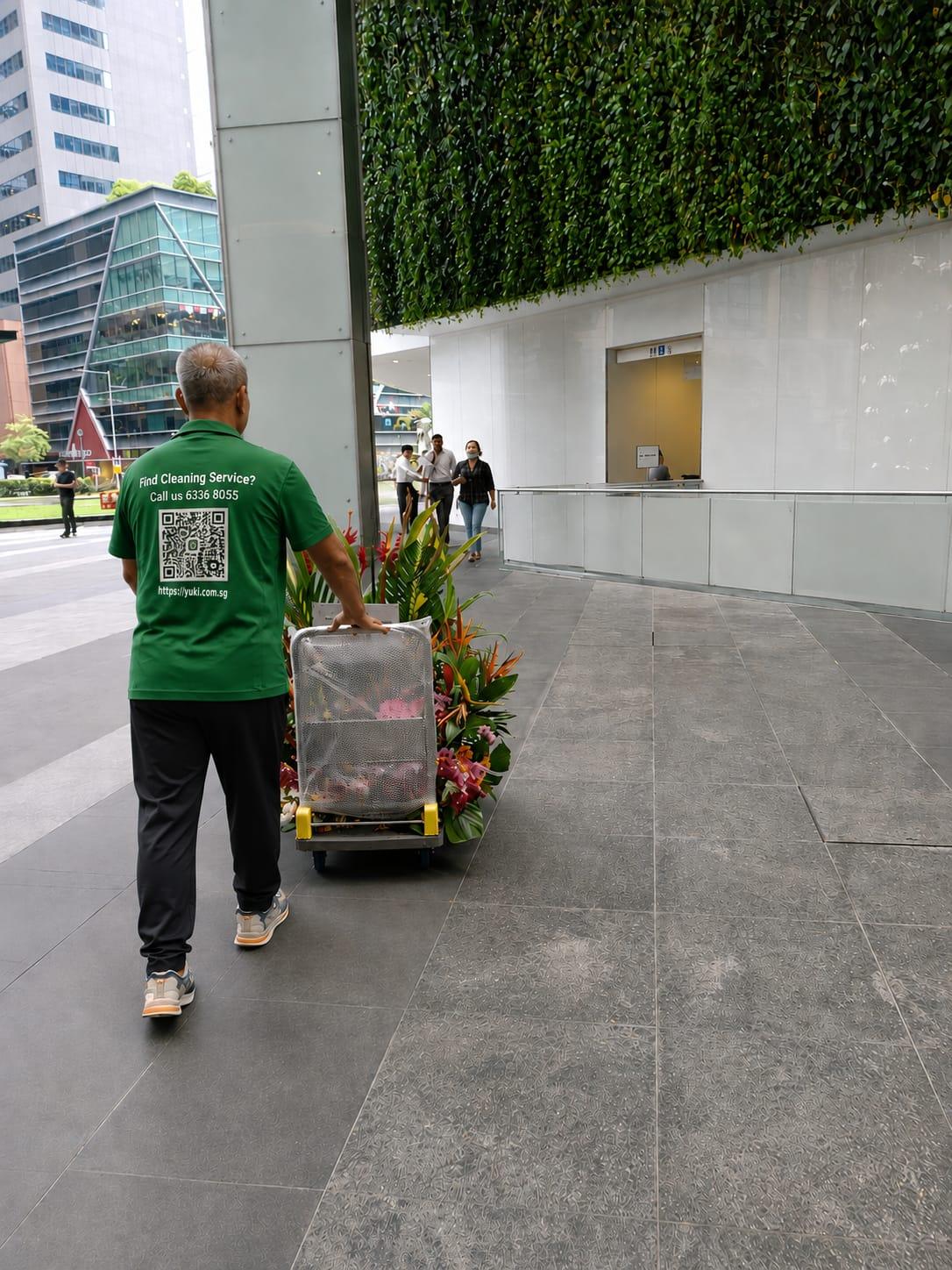 Congratulatory grand opening flower stand being delivered to an office building